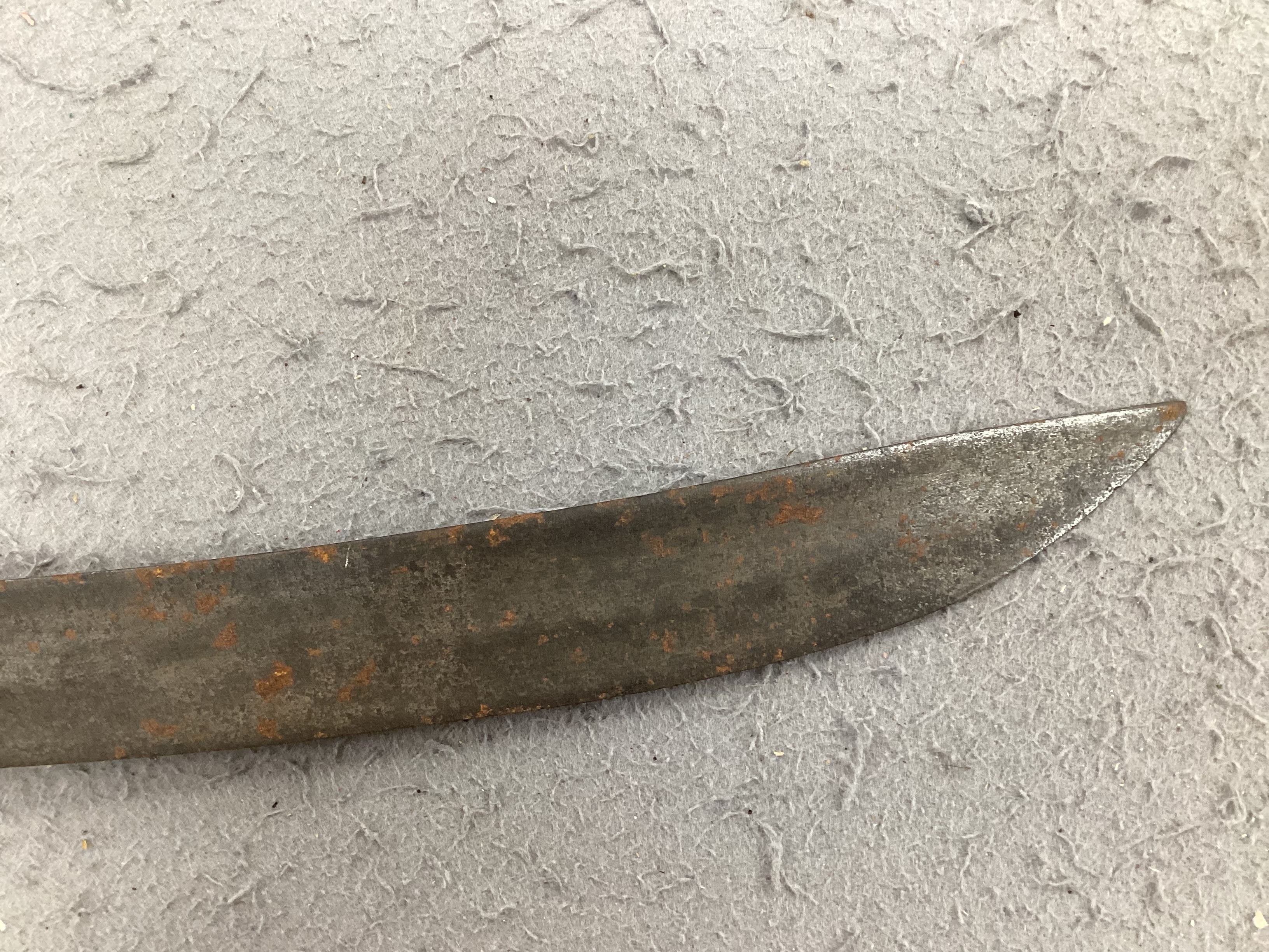 An English hangar, mid 17th century, curved fullered blade engraved with spurious date 1535 and running wolf mark, iron guard slightly reduced and swollen pommel, spirally carved and chequered bone grip, blade 67.5cm